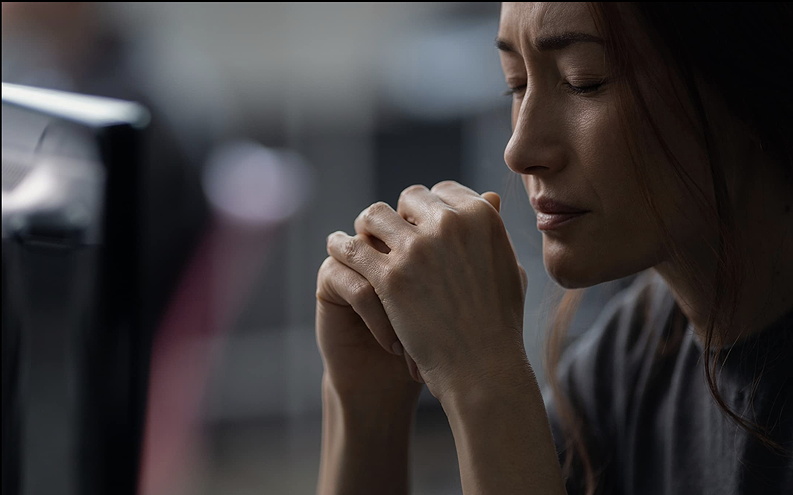 Actor Maggie Q, with eyes closed, looking reflective.